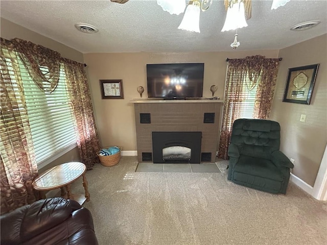 1047 N Lynn St, Nevada, MO 64772 - living area featuring a textured ceiling, carpet, a fireplace, and ceiling fan