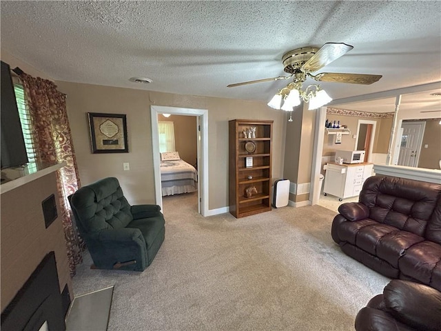1047 N Lynn St, Nevada, MO 64772 - carpeted living room featuring ceiling fan and a textured ceiling