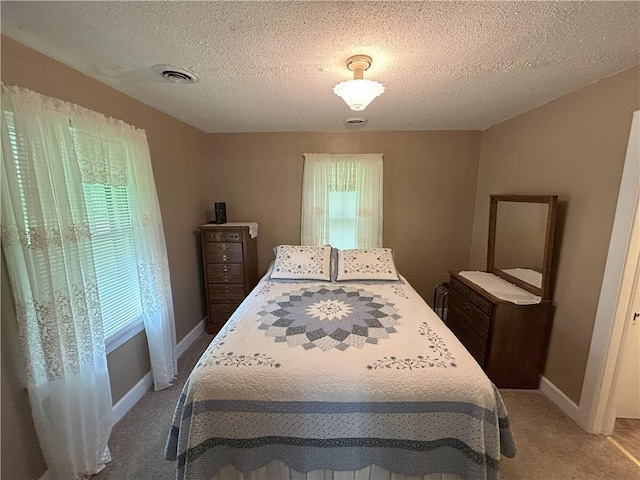 1047 N Lynn St, Nevada, MO 64772 - bedroom with light carpet and a textured ceiling