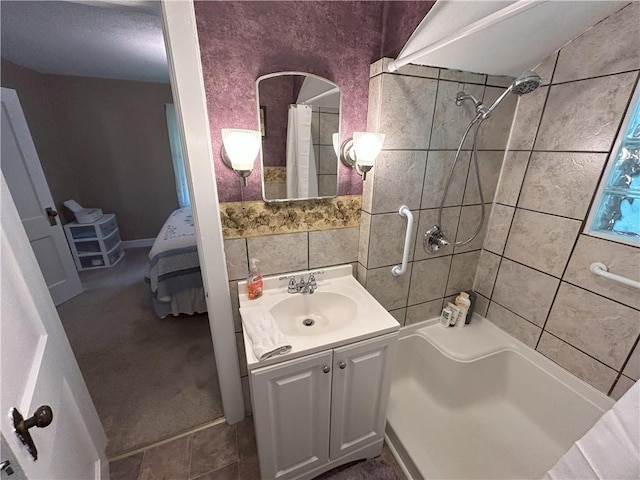 1047 N Lynn St, Nevada, MO 64772 - full bathroom with vanity, shower / tub combo with curtain, tile walls, and ensuite bath
