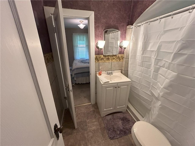 1047 N Lynn St, Nevada, MO 64772 - bathroom with vanity, tile patterned flooring, connected bathroom, and a shower with curtain