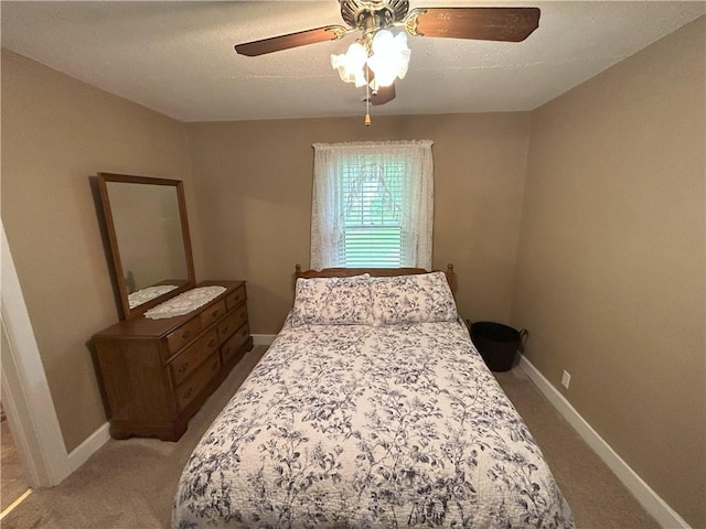 1047 N Lynn St, Nevada, MO 64772 - bedroom with light colored carpet, ceiling fan, and a textured ceiling