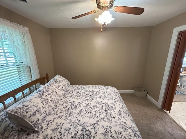 1047 N Lynn St, Nevada, MO 64772 - bedroom featuring carpet flooring, ceiling fan, and a textured ceiling