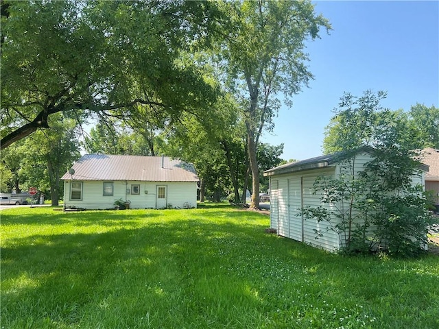 229 E Bates St, Drexel, MO 64742 - view of grassy yard featuring an outbuilding