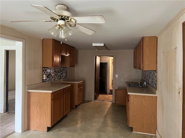 229 E Bates St, Drexel, MO 64742 - kitchen featuring decorative backsplash, brown cabinetry, ornamental molding, light countertops, and a ceiling fan