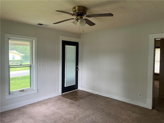 229 E Bates St, Drexel, MO 64742 - empty room with dark carpet and ceiling fan