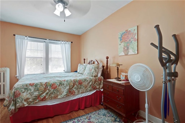 212 Emanuel Cleaver Ii Blvd Unit 2West, Kansas City, MO 64112 - bedroom with radiator, wood finished floors, and a ceiling fan