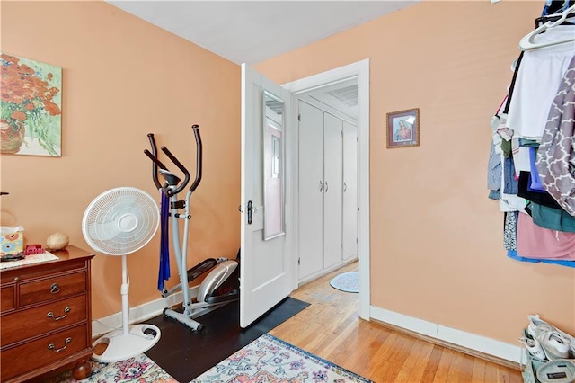 212 Emanuel Cleaver Ii Blvd Unit 2West, Kansas City, MO 64112 - exercise area with baseboards and light wood-style floors