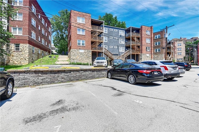 212 Emanuel Cleaver Ii Blvd Unit 2West, Kansas City, MO 64112 - view of apartment building / complex featuring uncovered parking
