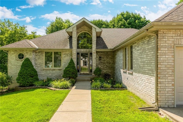 503 Amesbury Dr, Smithville, MO 64089 - view of front of house with brick siding, a front lawn, and roof with shingles