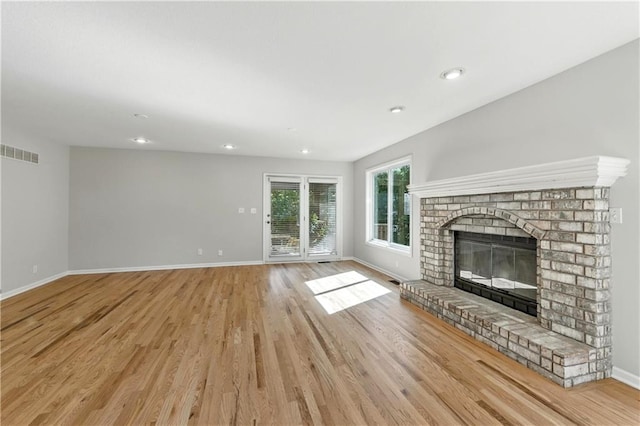 503 Amesbury Dr, Smithville, MO 64089 - unfurnished living room with light wood-type flooring, a fireplace, and recessed lighting