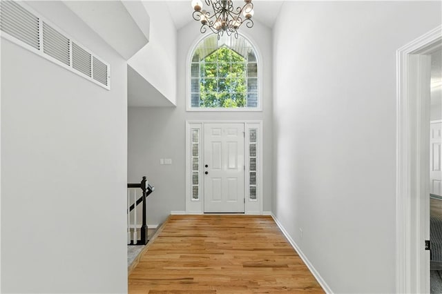 503 Amesbury Dr, Smithville, MO 64089 - entrance foyer featuring a chandelier, light wood-style flooring, and high vaulted ceiling