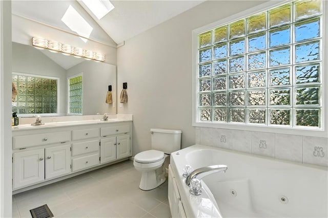503 Amesbury Dr, Smithville, MO 64089 - bathroom with vaulted ceiling, double vanity, a tub with jets, a skylight, and tile patterned flooring
