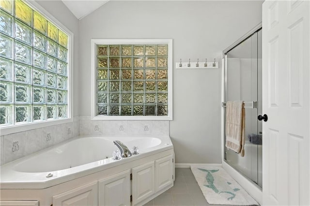 503 Amesbury Dr, Smithville, MO 64089 - bathroom featuring a shower stall, a bath, tile patterned floors, and vaulted ceiling