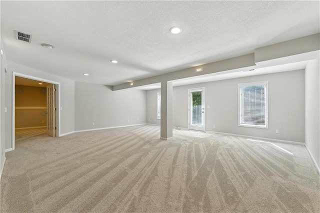 503 Amesbury Dr, Smithville, MO 64089 - unfurnished living room with light colored carpet, a textured ceiling, and recessed lighting