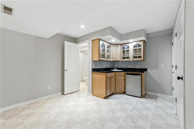 503 Amesbury Dr, Smithville, MO 64089 - kitchen featuring dishwasher, glass insert cabinets, dark countertops, recessed lighting, and light flooring