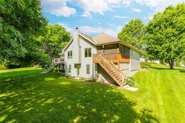 503 Amesbury Dr, Smithville, MO 64089 - rear view of house with stairs, a sunroom, a chimney, a yard, and a wooden deck