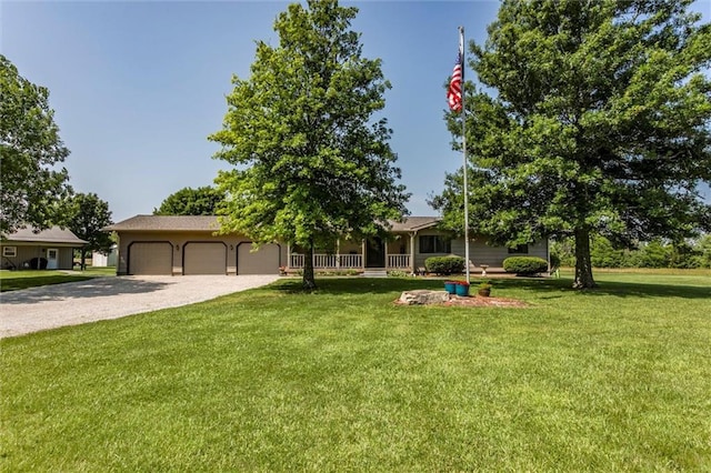 2450 Labette Rd, Ottawa, KS 66067 - view of property hidden behind natural elements featuring a front lawn, gravel driveway, and an attached garage