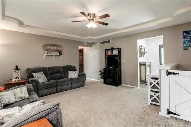 2450 Labette Rd, Ottawa, KS 66067 - living area with a raised ceiling, light colored carpet, and a ceiling fan