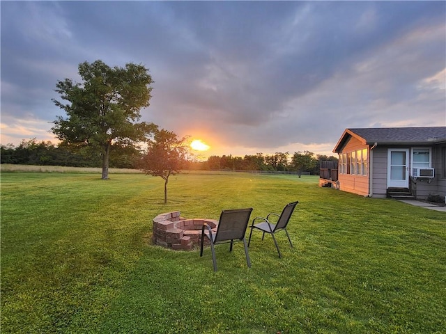 2450 Labette Rd, Ottawa, KS 66067 - view of green lawn with an outdoor fire pit and cooling unit