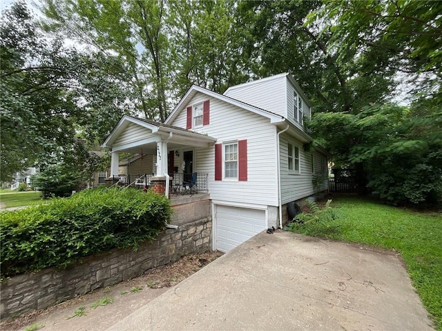 2122 S Scott Ave, Independence, MO 64052 - view of front of property featuring covered porch, concrete driveway, and an attached garage