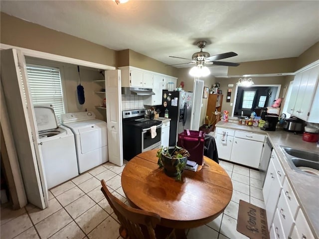 2122 S Scott Ave, Independence, MO 64052 - kitchen featuring stainless steel appliances, washing machine and dryer, under cabinet range hood, and light tile patterned flooring