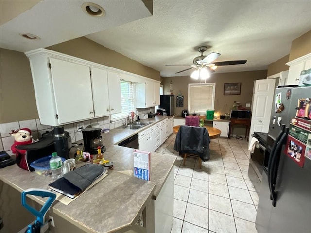 2122 S Scott Ave, Independence, MO 64052 - kitchen with refrigerator with ice dispenser, white cabinetry, ceiling fan, light countertops, and light tile patterned floors