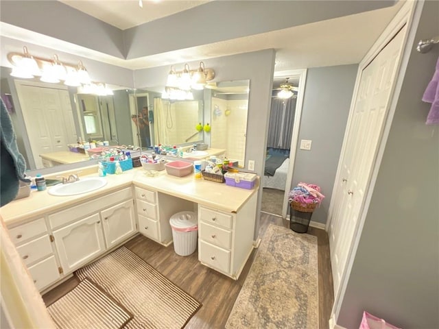 2122 S Scott Ave, Independence, MO 64052 - ensuite bathroom with vanity, wood finished floors, and ceiling fan