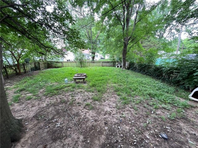 2122 S Scott Ave, Independence, MO 64052 - fenced backyard with a fire pit