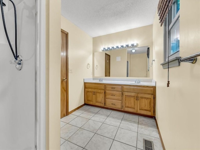 15409 Conser St, Overland Park, KS 66223 - bathroom featuring double vanity, a textured ceiling, tile patterned floors, and a shower