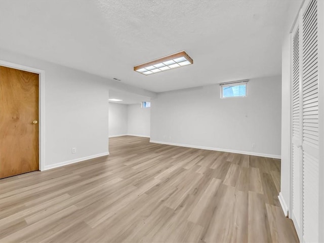 15409 Conser St, Overland Park, KS 66223 - below grade area featuring light wood finished floors and a textured ceiling