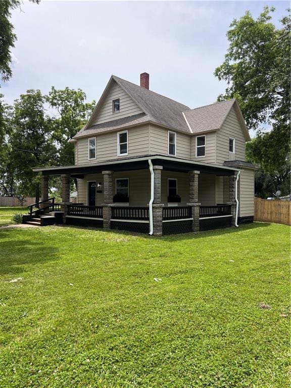 112 N High St, Butler, MO 64730 - rear view of property with a chimney and a porch