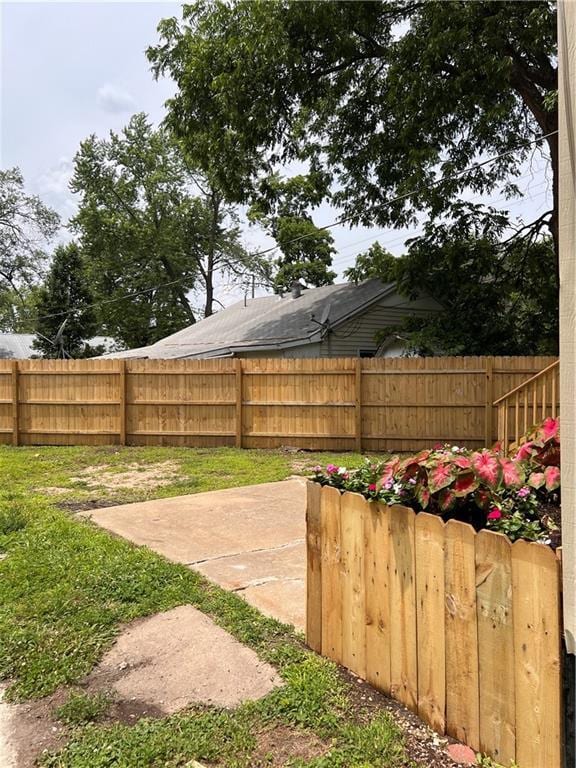 112 N High St, Butler, MO 64730 - fenced backyard with a patio