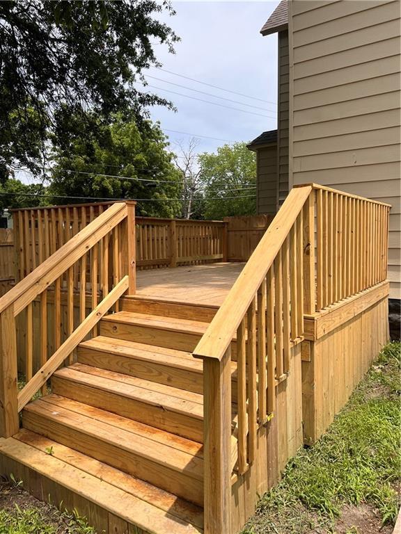 112 N High St, Butler, MO 64730 - wooden terrace featuring stairway