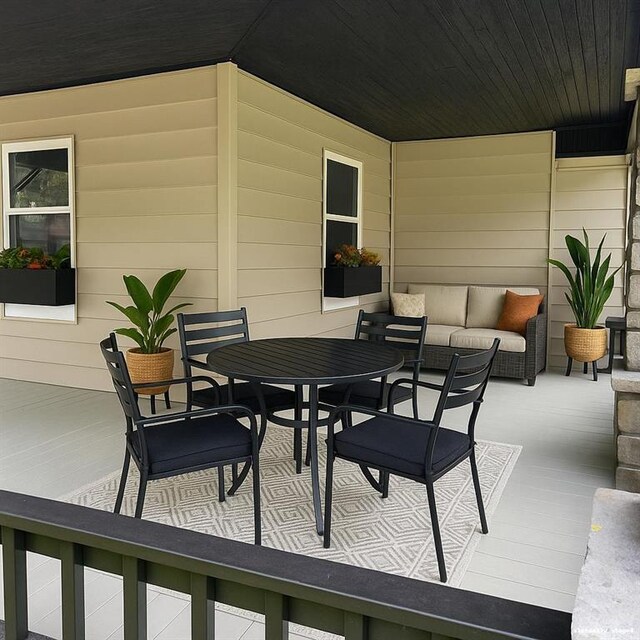 112 N High St, Butler, MO 64730 - wooden deck with outdoor dining area
