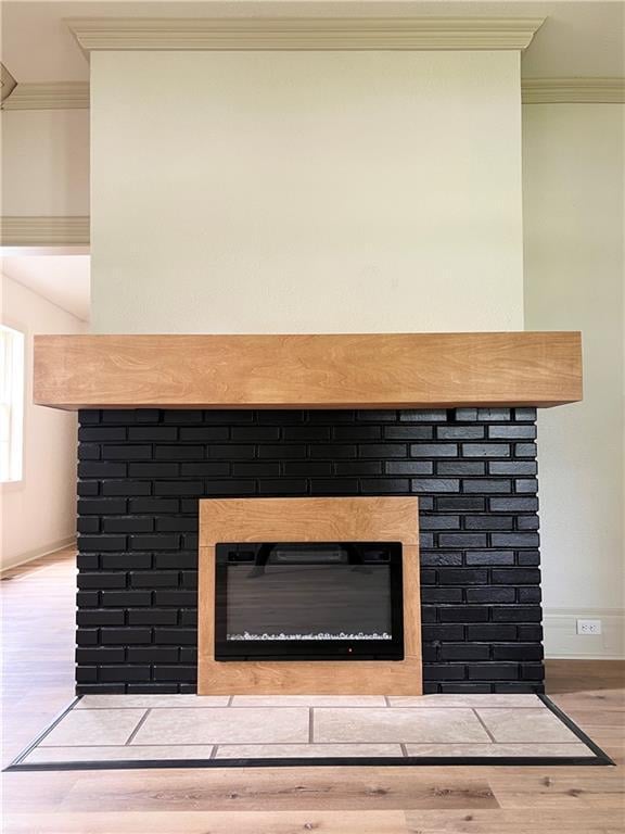 112 N High St, Butler, MO 64730 - detailed view of a fireplace, wood finished floors, and ornamental molding