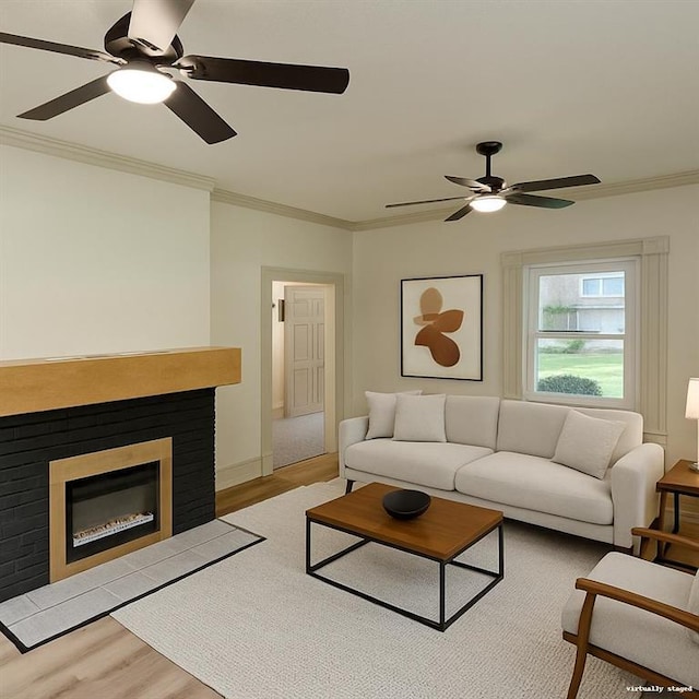 112 N High St, Butler, MO 64730 - living area featuring a ceiling fan, light wood-style flooring, a glass covered fireplace, and crown molding