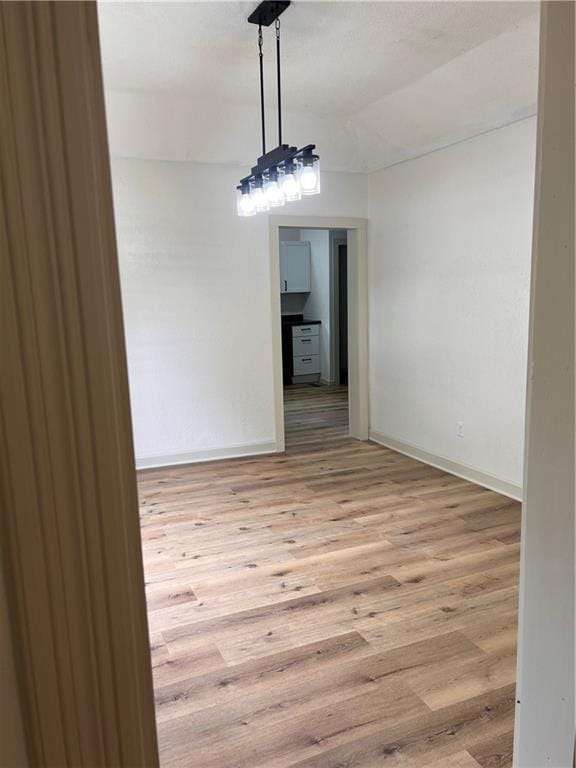 112 N High St, Butler, MO 64730 - spare room with light wood-style floors and baseboards