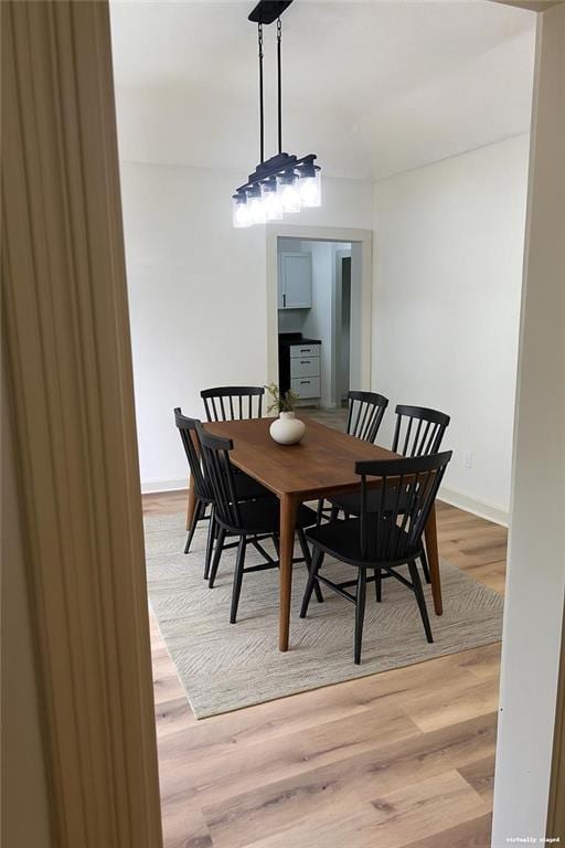 112 N High St, Butler, MO 64730 - dining space featuring light wood-style floors and baseboards