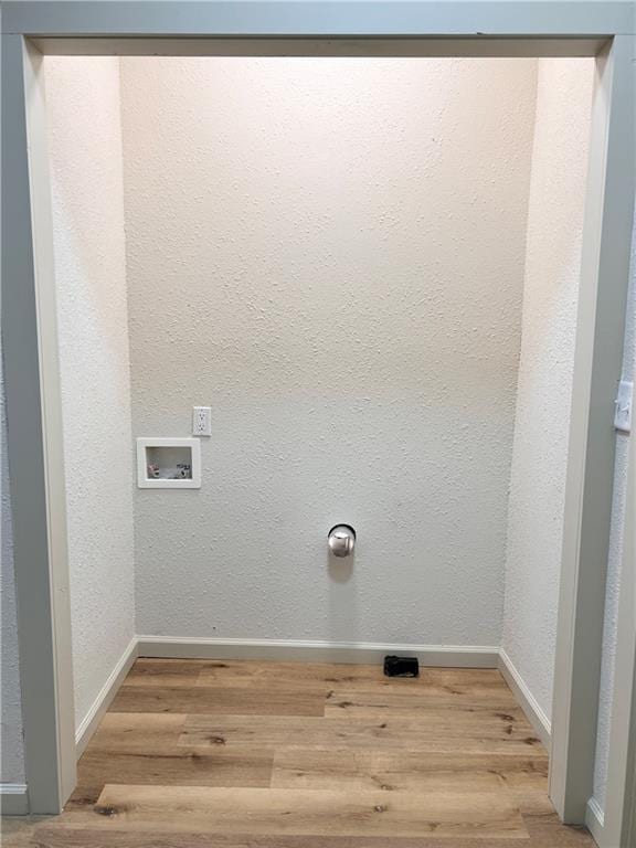 112 N High St, Butler, MO 64730 - washroom featuring wood finished floors and washer hookup
