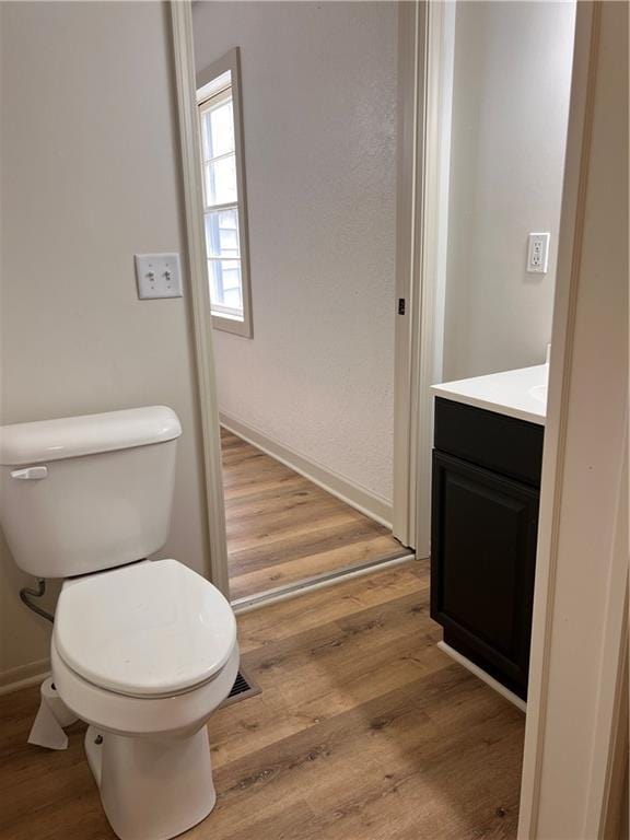112 N High St, Butler, MO 64730 - bathroom featuring vanity and wood finished floors