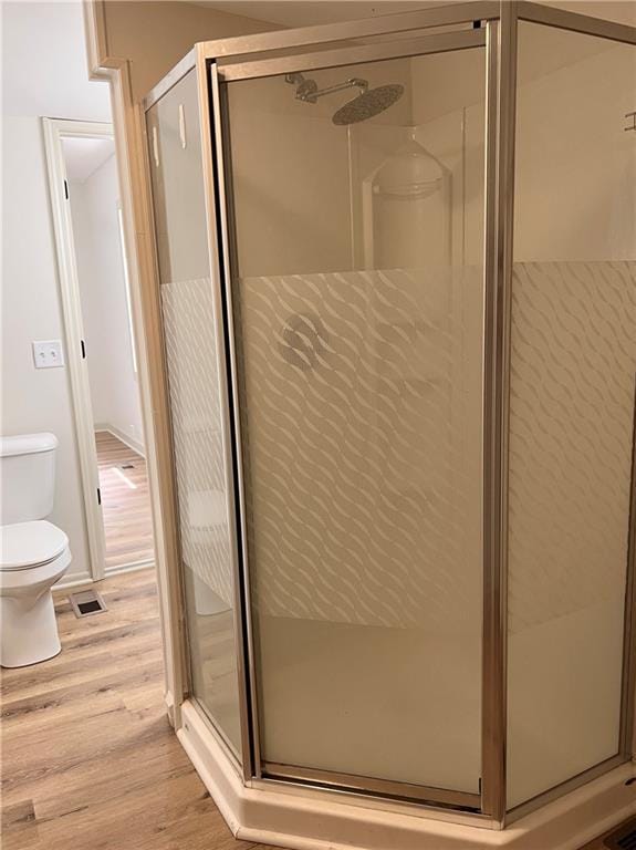 112 N High St, Butler, MO 64730 - full bath featuring wood finished floors and a stall shower