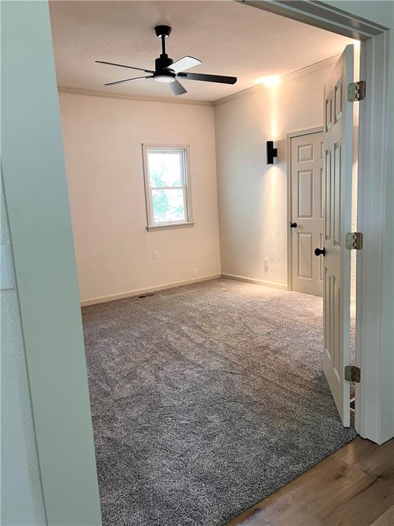 112 N High St, Butler, MO 64730 - carpeted spare room featuring ceiling fan and crown molding