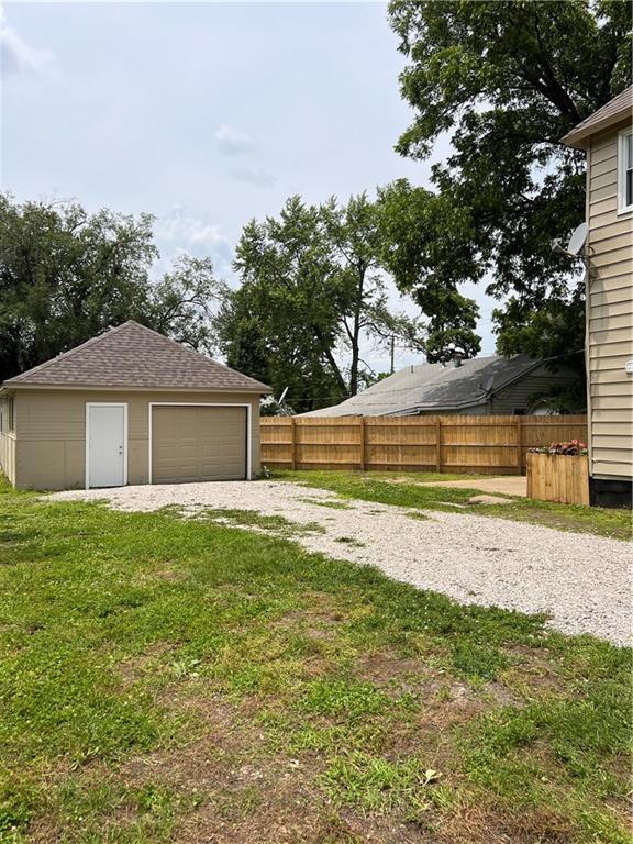 112 N High St, Butler, MO 64730 - view of yard with a garage and an outdoor structure