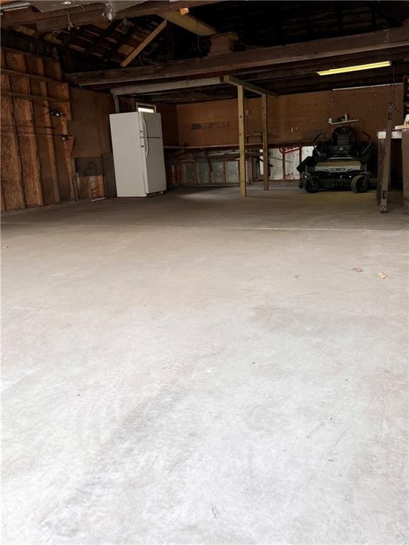 112 N High St, Butler, MO 64730 - garage featuring freestanding refrigerator