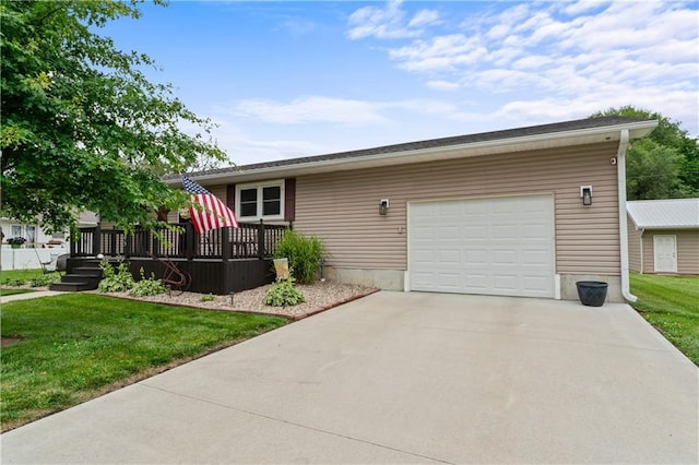 505 S Magdalena St, Concordia, MO 64020 - view of front of house with concrete driveway, a front yard, an attached garage, and a deck