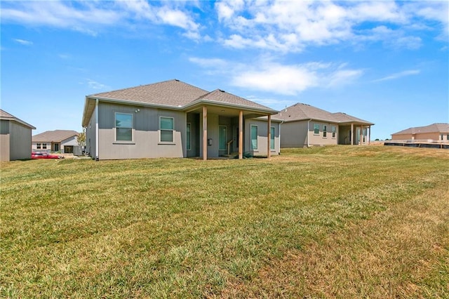 9119 N Cleveland Ave, Kansas City, MO 64156 - rear view of property featuring a yard