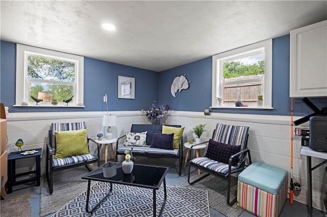 2508 Vernon Ave, Kansas City, KS 66104 - living area featuring healthy amount of natural light, wainscoting, and concrete flooring