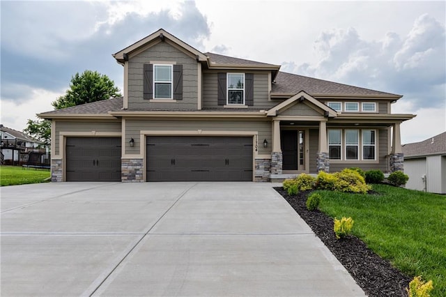 11704 N Laurel Ave, Kansas City, MO 64157 - craftsman inspired home featuring a front lawn, concrete driveway, stone siding, an attached garage, and roof with shingles