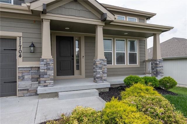 11704 N Laurel Ave, Kansas City, MO 64157 - doorway to property featuring a porch and stone siding